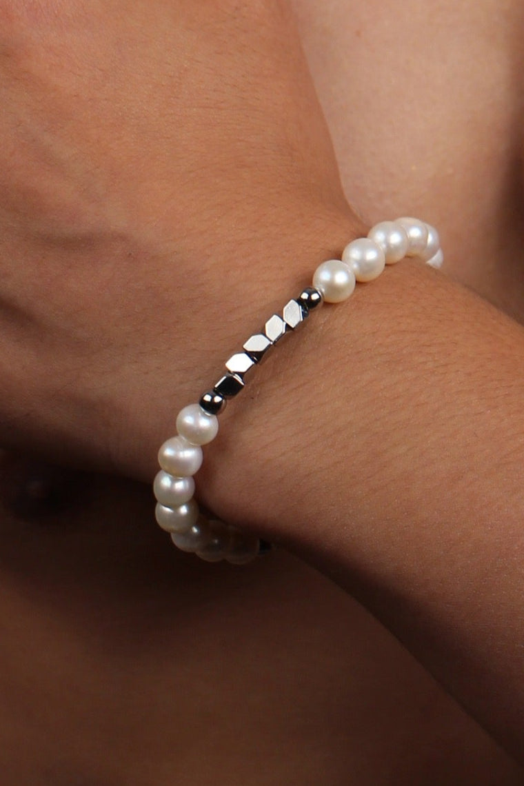 Men wearing a shining white pearl strand bracelet