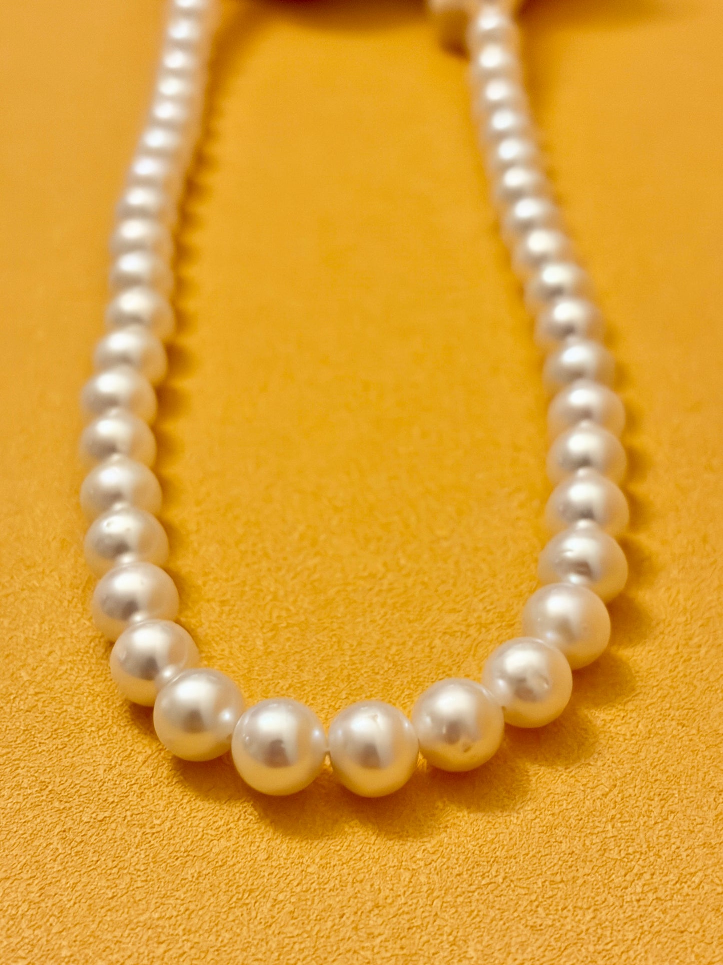 Pearl necklace on a yellow background