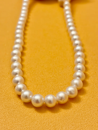 Pearl necklace on a yellow background