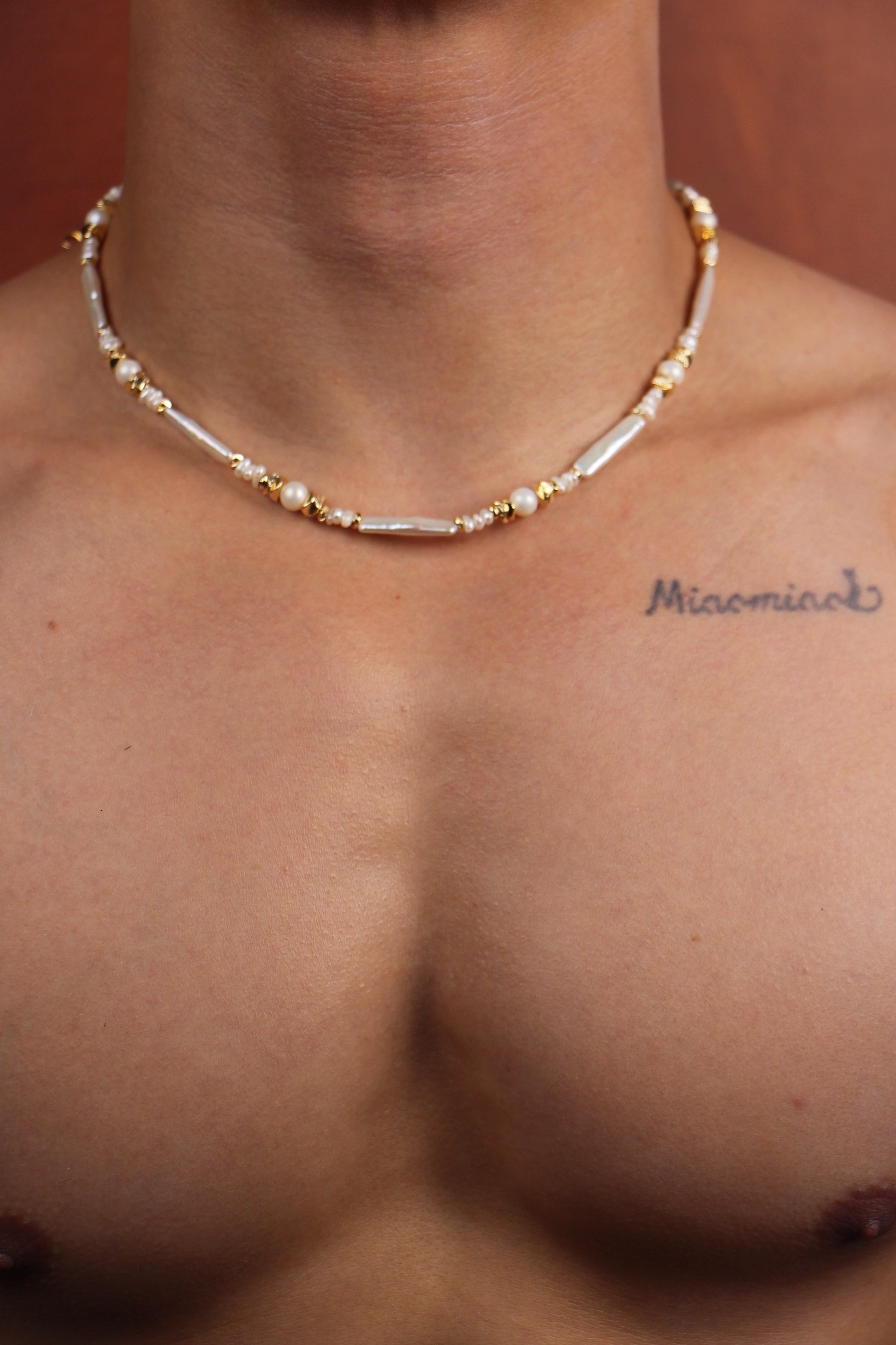 Men wearing pearl necklace with white Keshi and round pearls