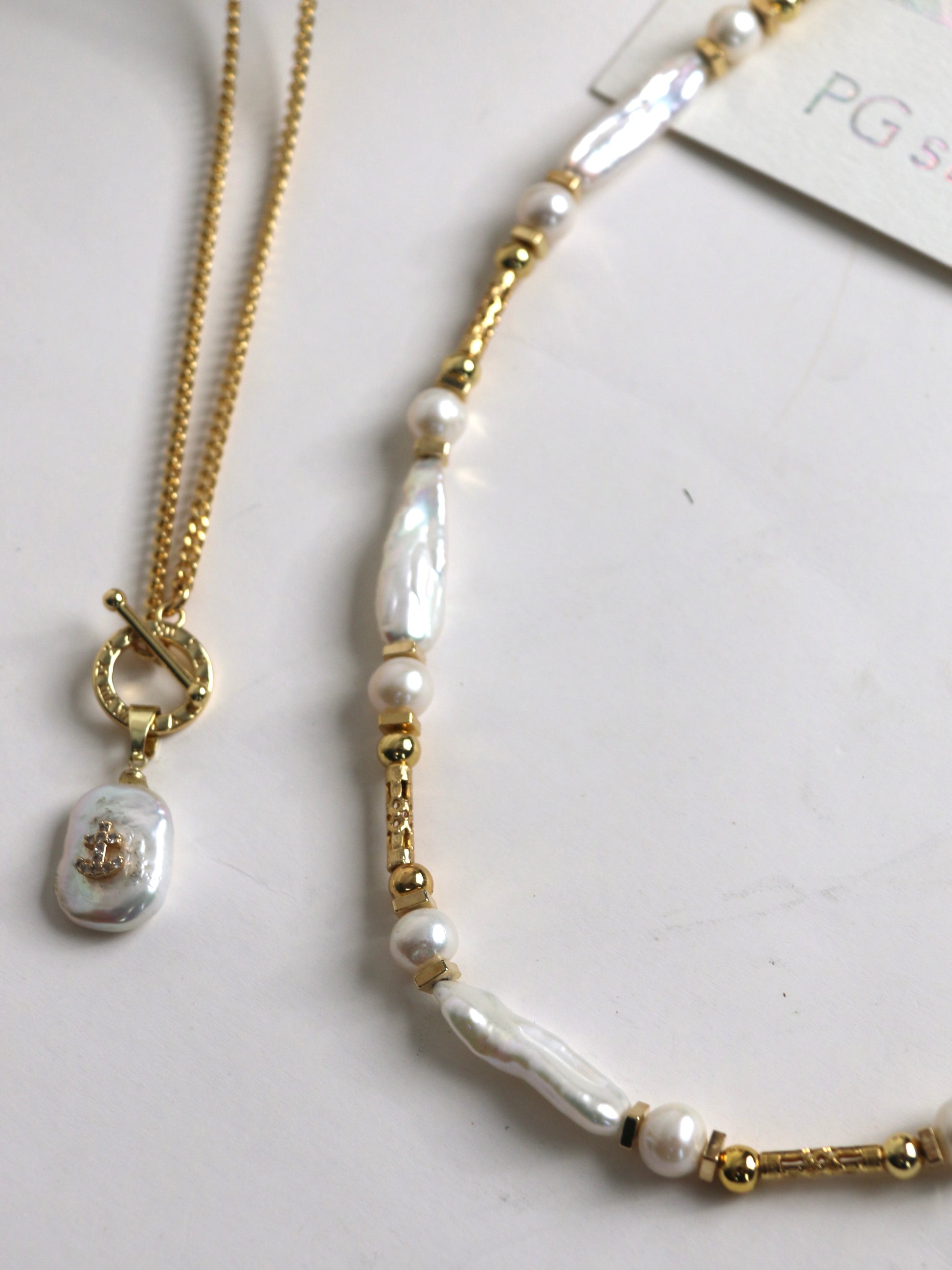 Pearl and gold necklace for men on a white background