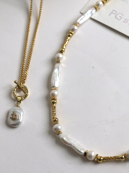 Pearl and gold necklace for men on a white background