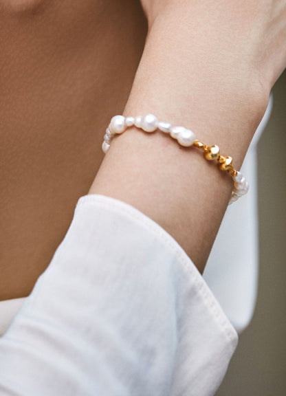 Pearl bracelet on a wrist with a blurred background