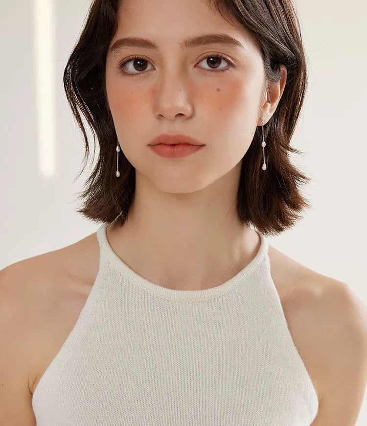 a model is wearing a White Freshwater Pearl Chandelier Earrings