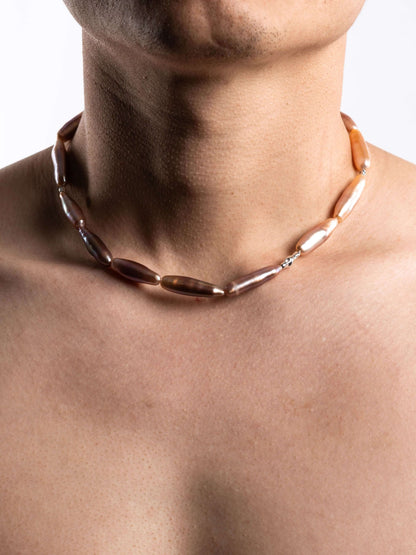 Pearl Necklace on a person with a neutral background