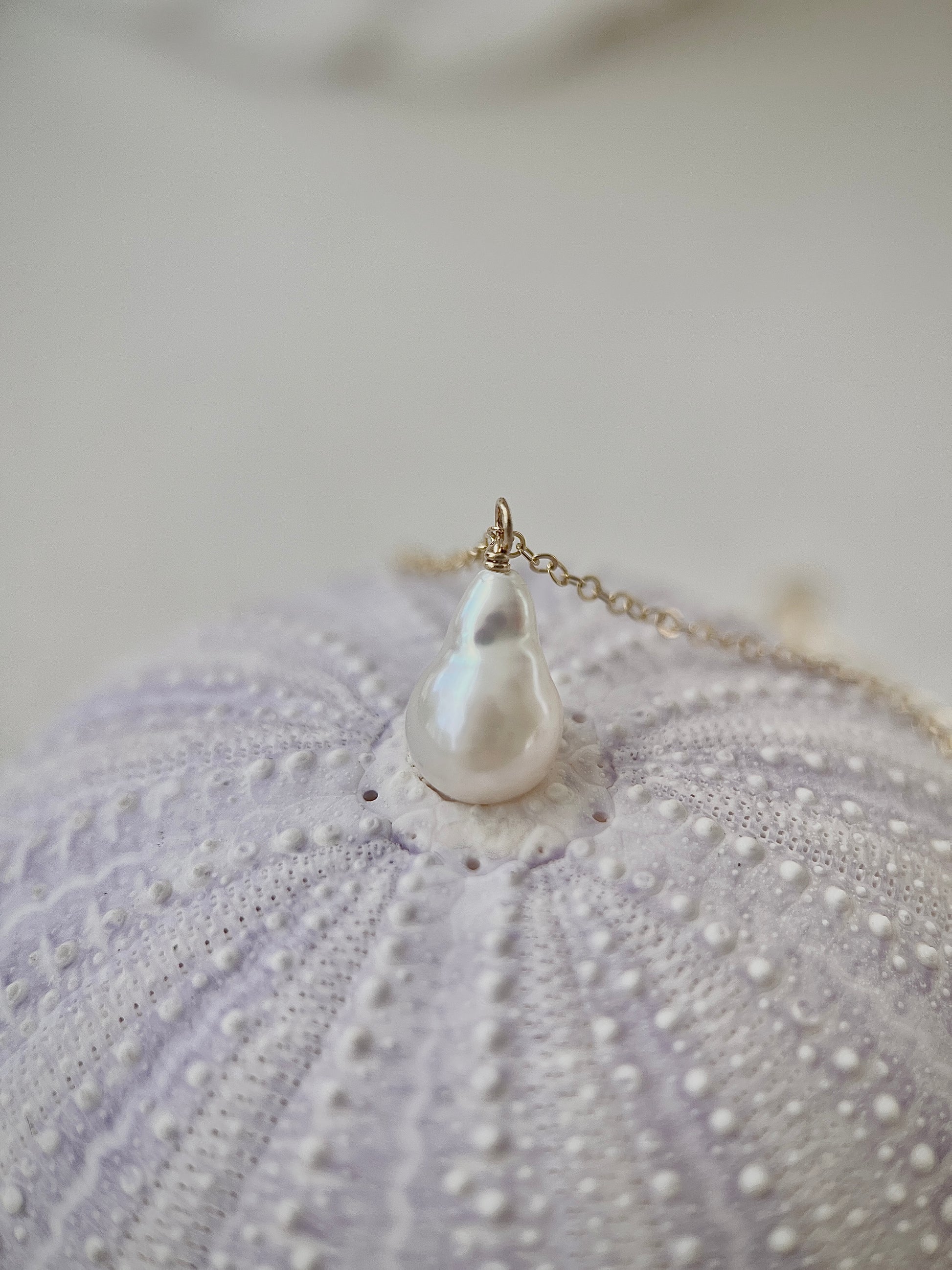 Pearl necklace on a textured surface