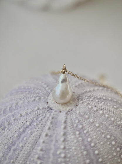 Pearl necklace on a textured surface